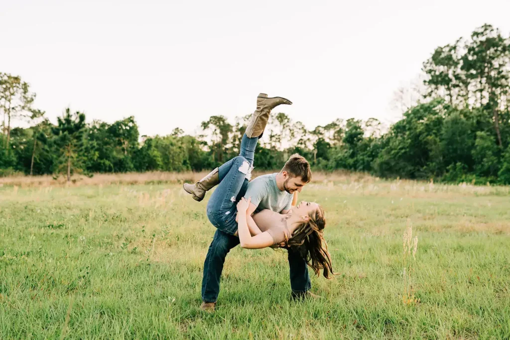 Man dips woman for enagement shoot in large field in FL