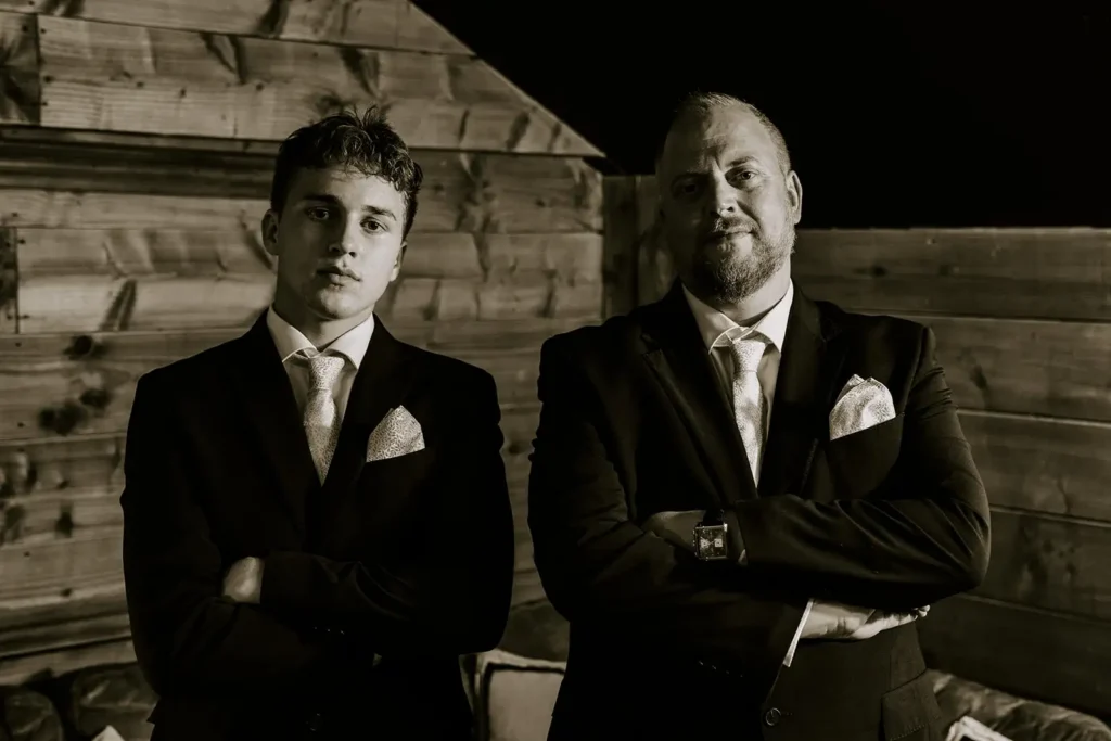 black and white photo of groom and son at wedding
