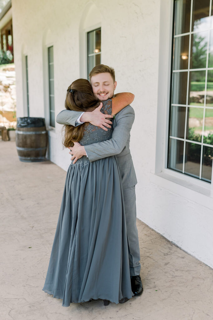son hugs mother during first look