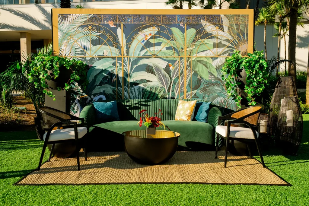 Outside tropical seating arrangement for corporate event reception