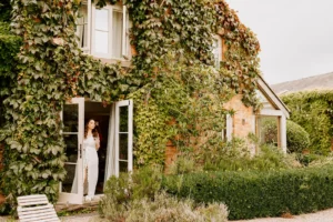 Bride standing in open doors at private estate wedding venue in the UK