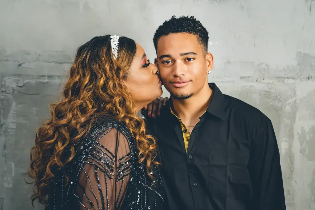 Mom kisses son during senior photo session
