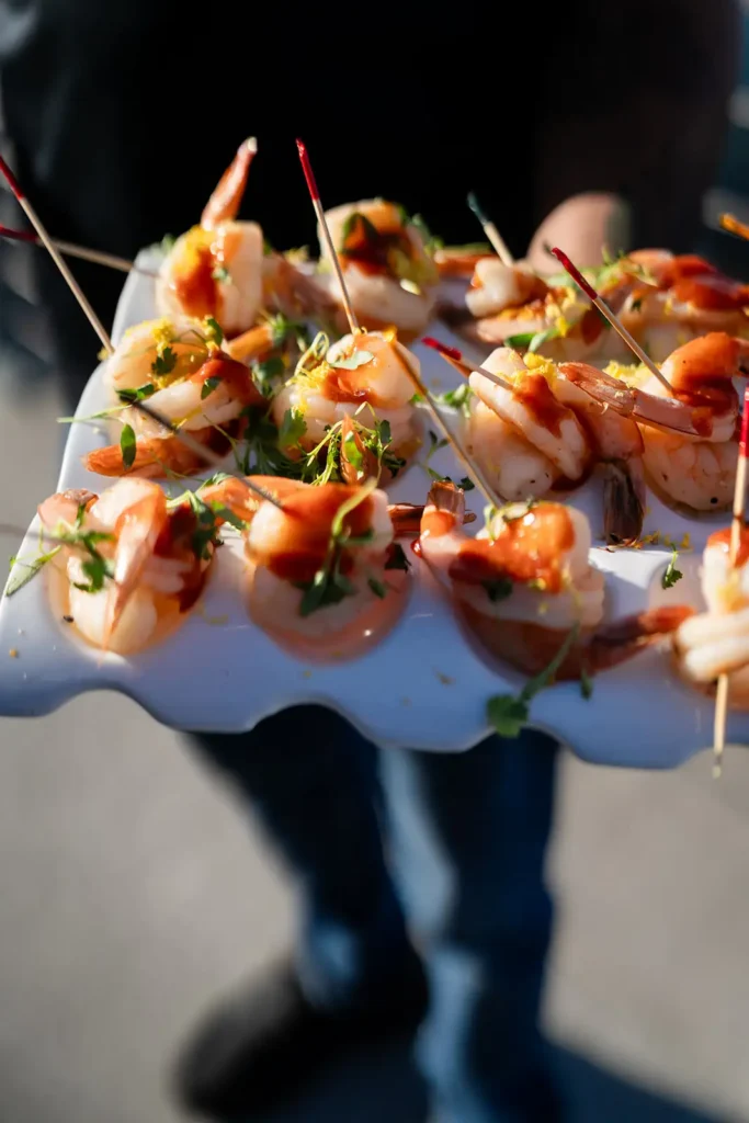 Waiter serves shrimp appetizers