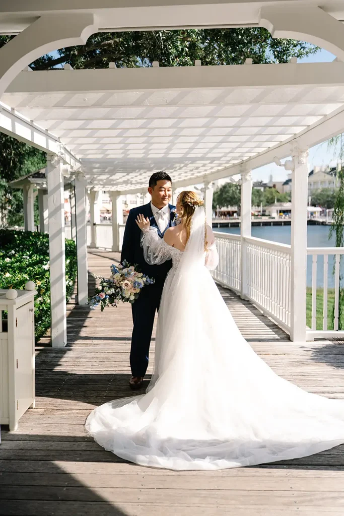 Bride and groom under pergola at Walt Disney World Swan Reserve