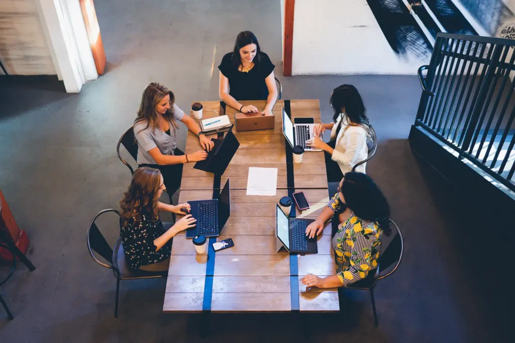 Small company business meeting around wooden table