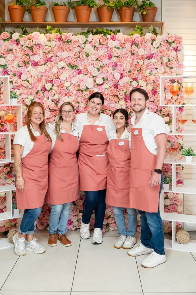 Staff wearing pink aprons