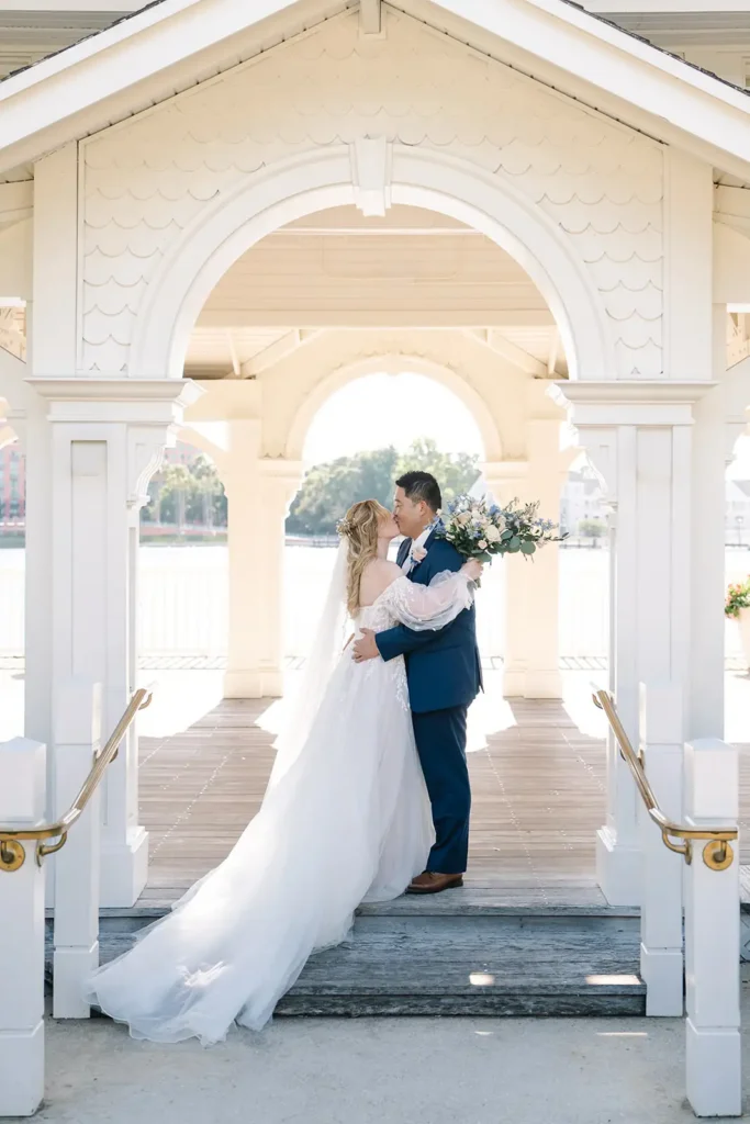 Bride and groom kissing for wedding portrait at Swan Reserve Disney