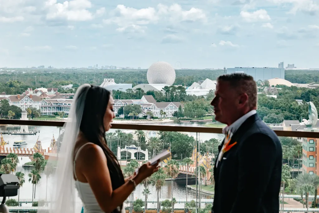 Bride shares vows with groom with Epcot in background