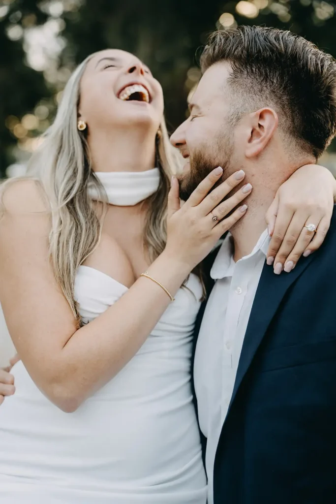 Woman laughing at man in photo shoot