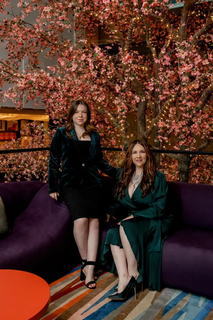 Female engagement shoot on purple couches and indoor pink tree