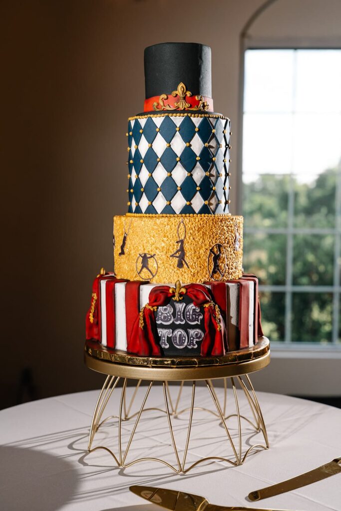 Circus themed four tier wedding cake with top hat topper