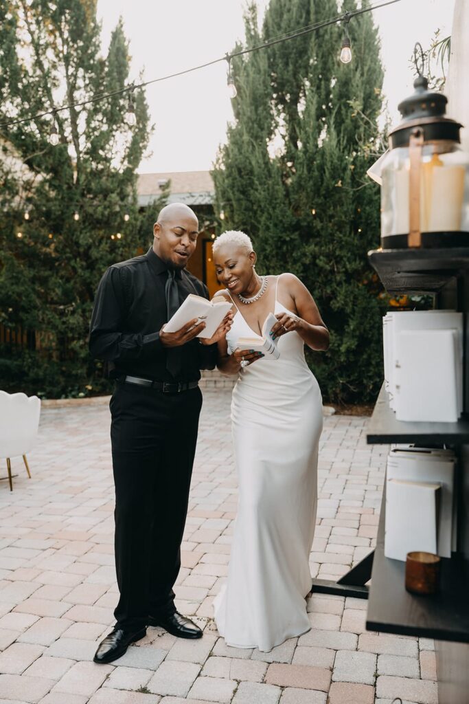 Bride and groom read the entries in their guest books