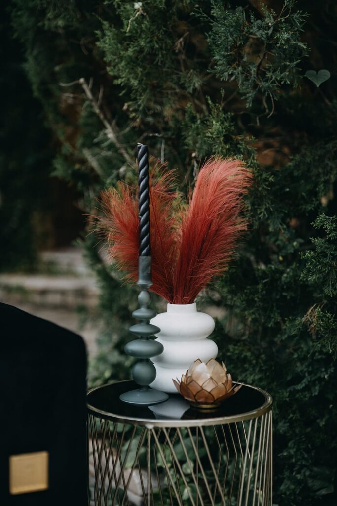 Red and black wedding decor on a small side table