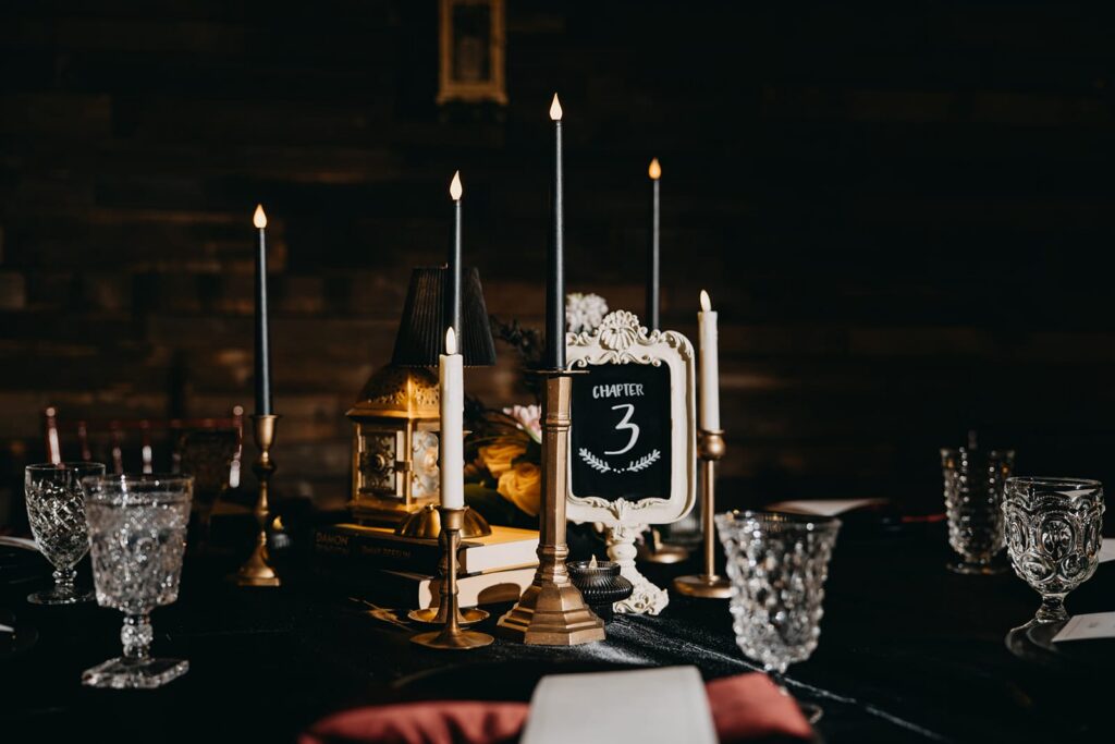 Dark and moody wedding reception table number and candles