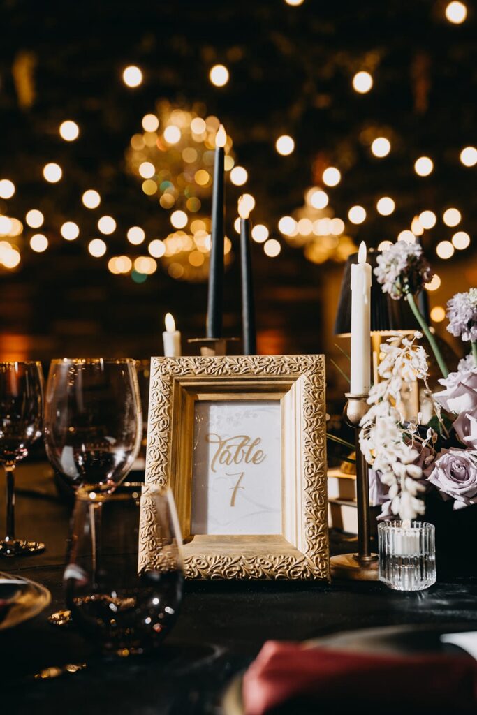 Detail photo of dark and moody wedding reception table centerpiece