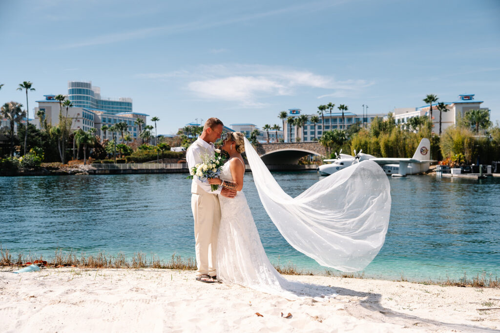Bride and groom embracing on the beach at Polynesian Beach Reasort